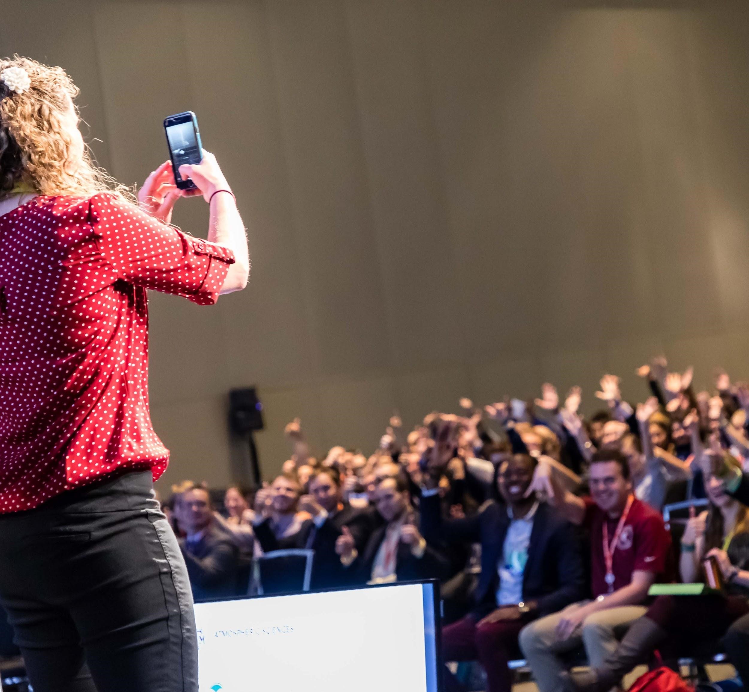 Stacey Hitchcock, a co-chair for the AMS Student Planning Committee, captures a photo of attendees at the AMS Student Conference 2018.