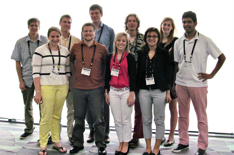 MEMBERS OF THE SPS CHAPTER AT ST. MARY'S COLLEGE OF MARYLAND pose for a photo by themselves (top) and with Flat Feynman (left). Photos courtesy of Jon Kwolek.