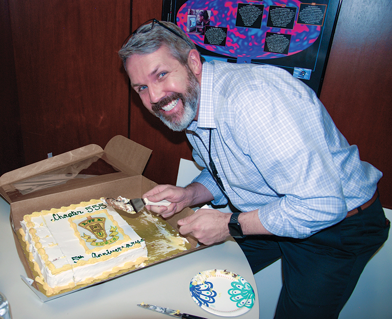 Lieutenant Colonel (ret.) Monte Anderson cuts the cake.