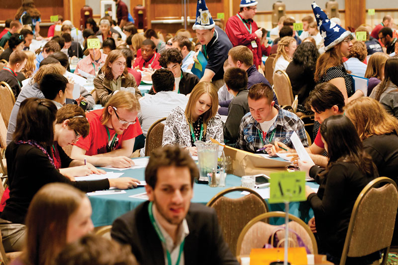 Attendees engaged in discussions at various workshops, while moderators known as &quot;Workshop Wizards&quot; wandered around facilitating discussions.