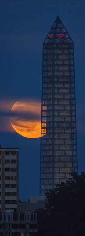 June's supermoon, which appeared as much as 13.5 percent larger and 30 percent brighter than a typical full Moon, is shown here behind the Washington monument. Image courtesy of NASA/Bill Ingalls.