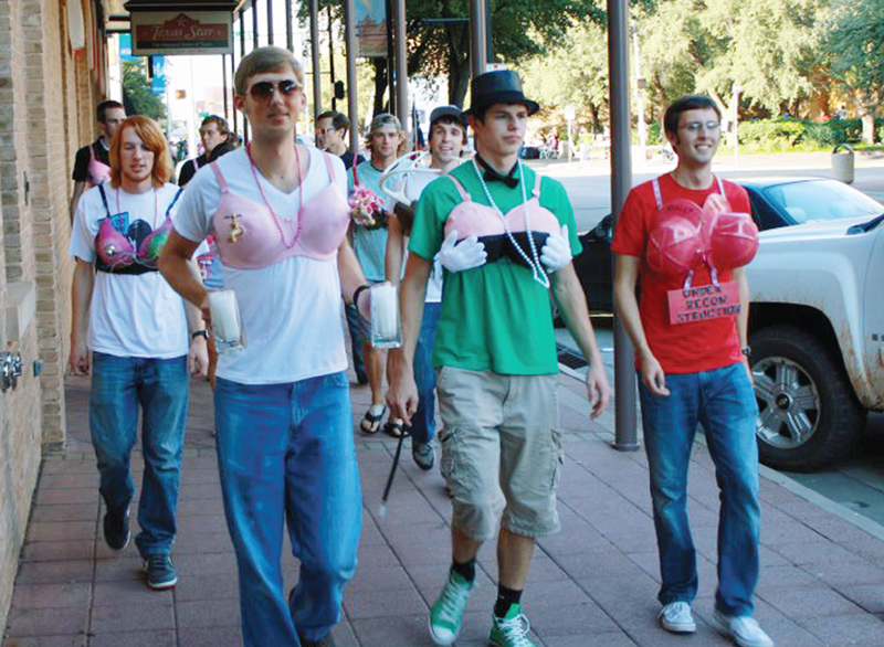 ACU SPS members act as human canvases for a breast cancer awareness project. Photo by Tim Head.