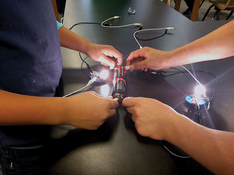 Elementary school students build circuits and light bulbs during an afterschool program organized by Guilford College's SPS chapter. Photos courtesy of Steven Shapiro.