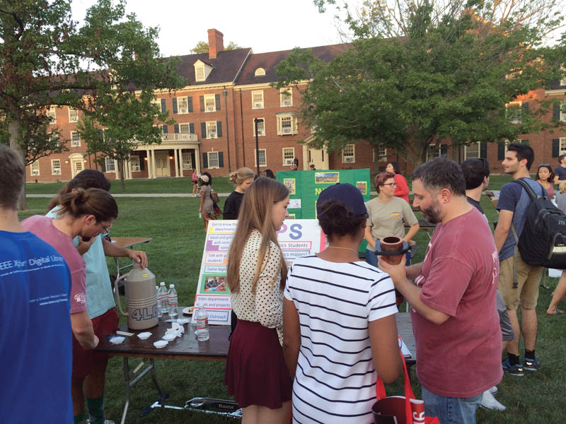 Members of the Miami University of Ohio SPS chapter demonstrate Lenz’s law and the Meissner effect at Mega Fair, a campus-wide event which allows organizations to recruit new members. Photo courtesy of Amber Williams. 