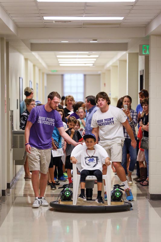 SPS students Michael Beale (purple shirt) and Noah Novembre (white shirt) inspire visitors with a hovercraft.