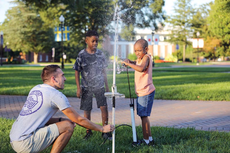 Volunteer Jonah Winkler helps attendees launch water bottles. Photos courtesy of High Point University.