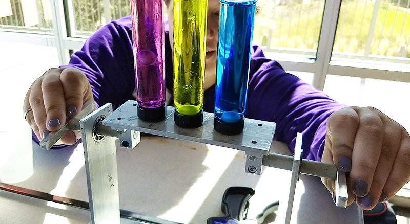 An SPS volunteer at the Denver Children’s Museum conducts a viscosity demonstration.