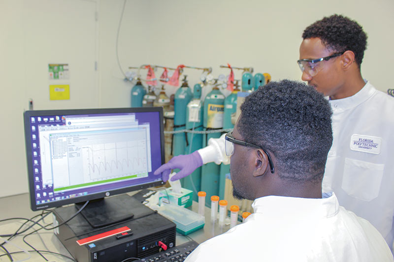 Undergraduate research students Mc Ben Joe Charles and Jared Nurse working on the thermogravimetric analysis of dolomite samples. Photo courtesy of Dr. Sesha Srinivasan. 