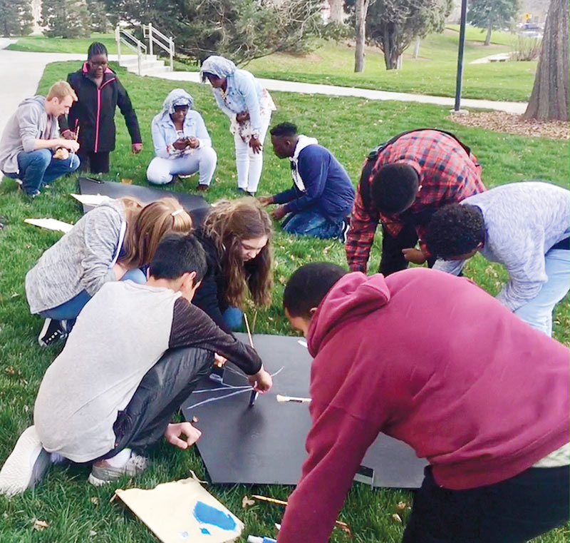 Students begin designing three panels of art depicting a cosmic journey through time. Photo courtesy of Teddy Anderson.