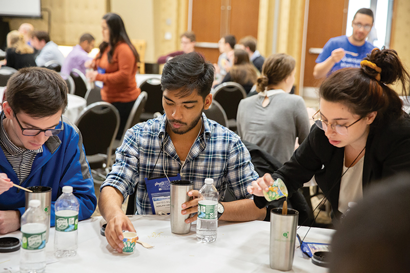 Students prepare pasta using a passive cooking model in a PhysCon workshop led by Carla Ramsdell. Photo credit - Society of Physics Students National Office.