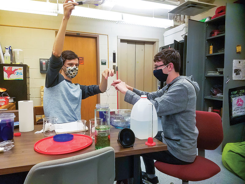 Project members observe the behavior of goop made with a new recipe, which turned out to be too non-Newtonian to coil. Photos courtesy of Ben Hayward.