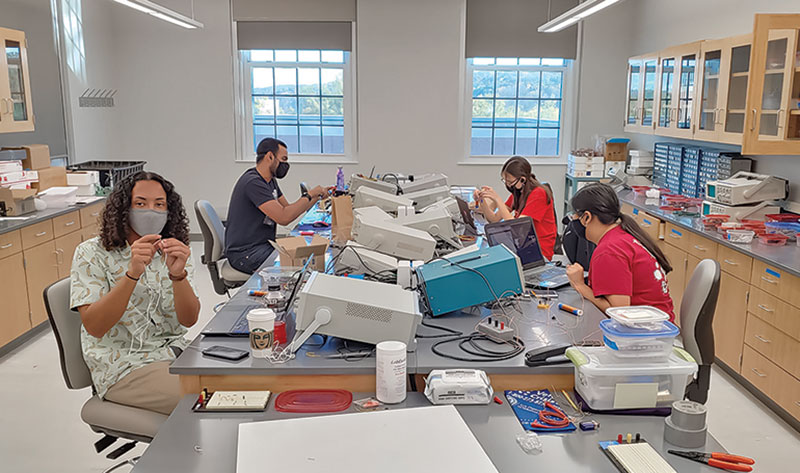 SPS members (L to R) Sam Williams, Anith Muthalaly, Caitlyn Fischer, and Krislyn Sourivong teach students how to construct radios over Zoom. 