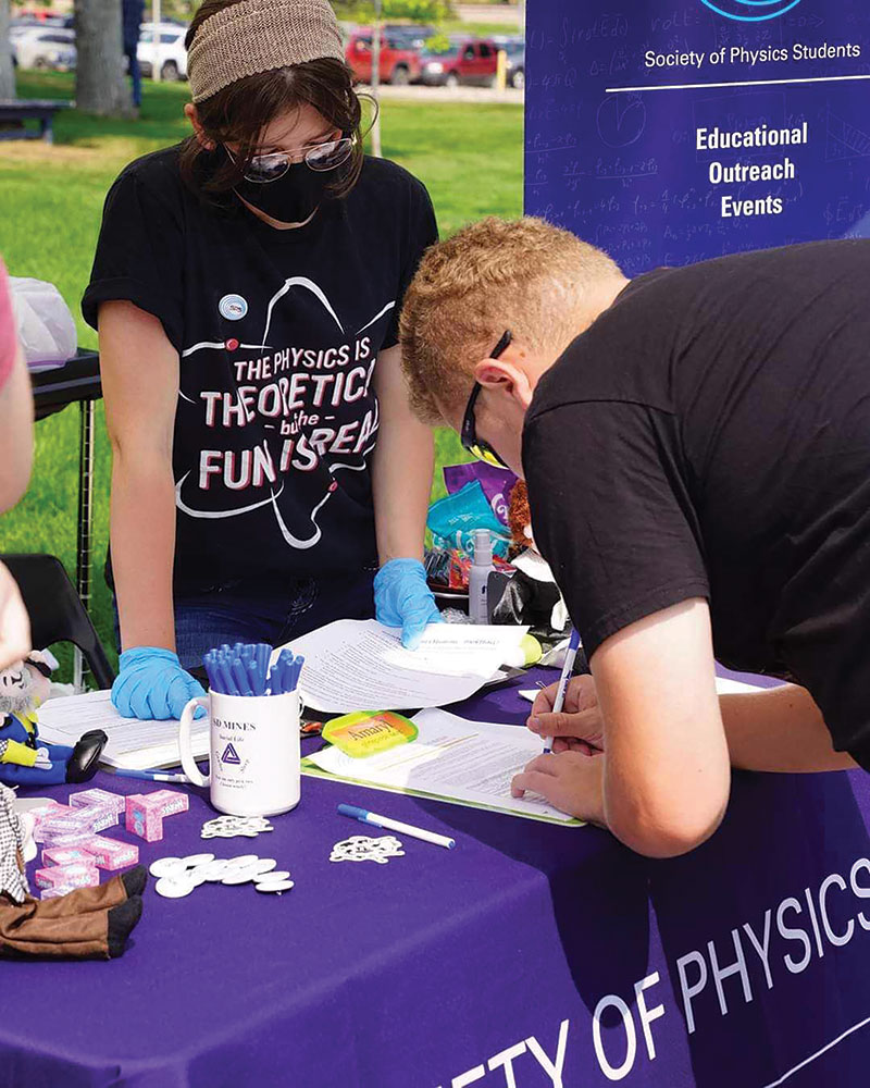 Serenity Engel, SPS chapter president at South Dakota School of Mines and Technology, introduces students to SPS at the 2020 campus organization fair. Photo courtesy of Serenity Engel. 