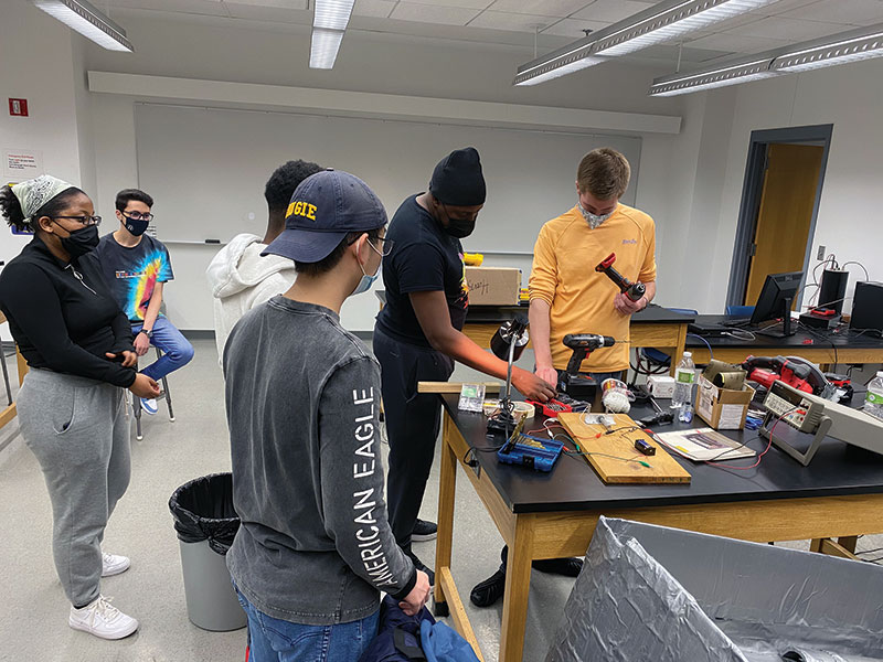 Members of the Augustana Physics and Engineering Society construct a cardboard regatta.