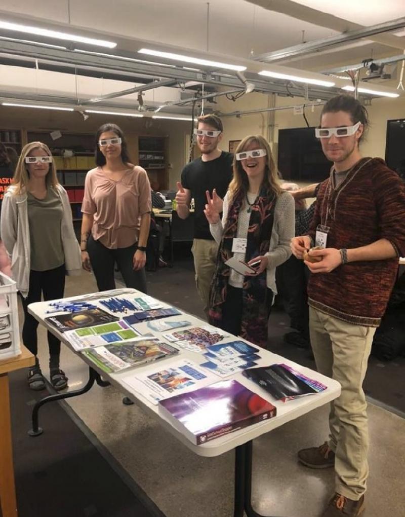 Attendees trying on SPS eclipse glasses during breakfast.