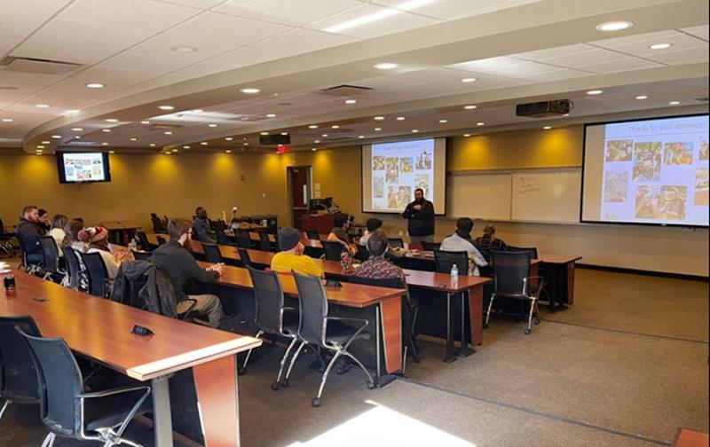 Dr. Jason Keleher giving a research presentation on chemical-mechanical planarization (CMP).