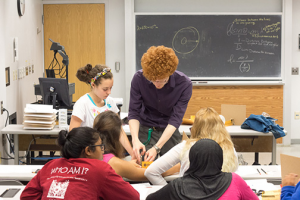 Helping a group of students at the UMD physics camp get their apparatus set up.