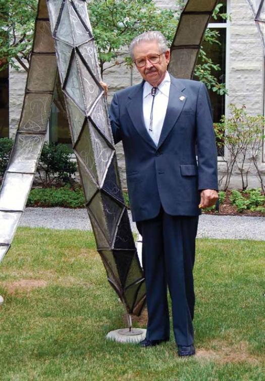 Worth Seagondollar poses by a sculpture at the American Center for Physics, following a 2007 talk and  Q&amp;A about his experiences working on the Manhattan Project. Photo by Tracy Nolis-Schwab.