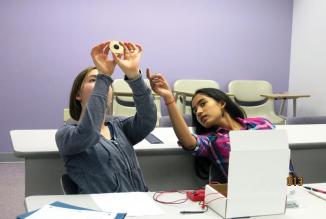 Students at a science camp test out SOCK activities. Photo by Kendra Redmond,  used with permission from the University of Maryland, College Park, Physics Department.