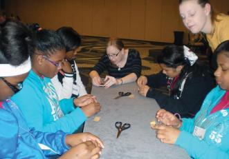 SPS and AAPt host an outreach event at each AAPT Winter Meeting. Volunteers from both organizations engage with approximately 100 local students in grades six through eight. Shown here,  students from New Orleans participate in the 2013 event.  Photo by Lydia Quijada.