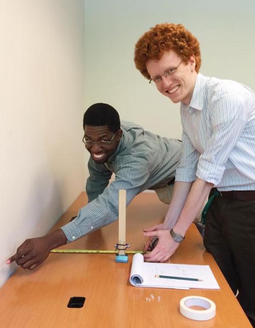 SPS Interns Kearns Louis-Jean (left) and Mark Sellers  develop demonstrations for the 2014-15 SPS SOCK (Science Outreach Catalyst Kit). The kits may be ordered from the SPS National Office to kick-start chapter outreach efforts. Learn more and peruse recent SOCK kits at www.spsnational.org/ programs/socks/. Photo by Courtney Lemon.